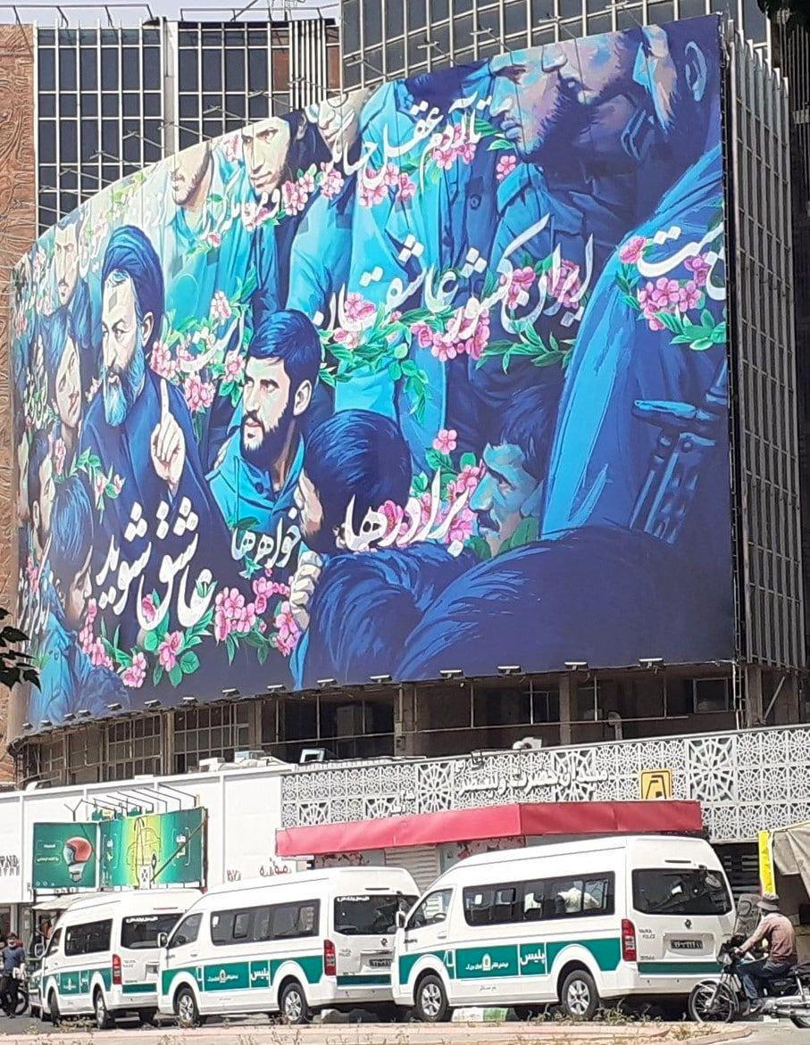 تصویری پربازدید در شبکه‌های اجتماعی | ون‌های گشت ارشاد، میدان ولیعصر زیر بنر تبلیغاتی شهید بهشتی